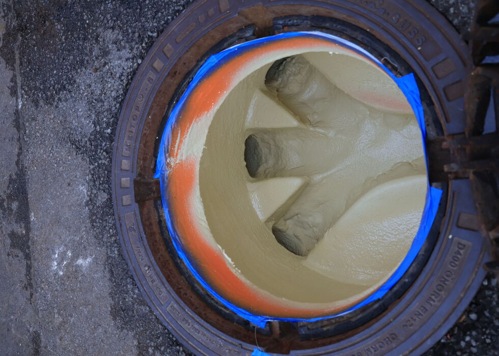 Close-up of thick soup boiling inside a metal pot, viewed from above.